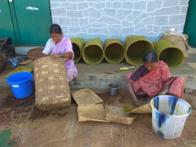 Women preparing baskets in the traditional method of seed storage under the supervision of Vasantha